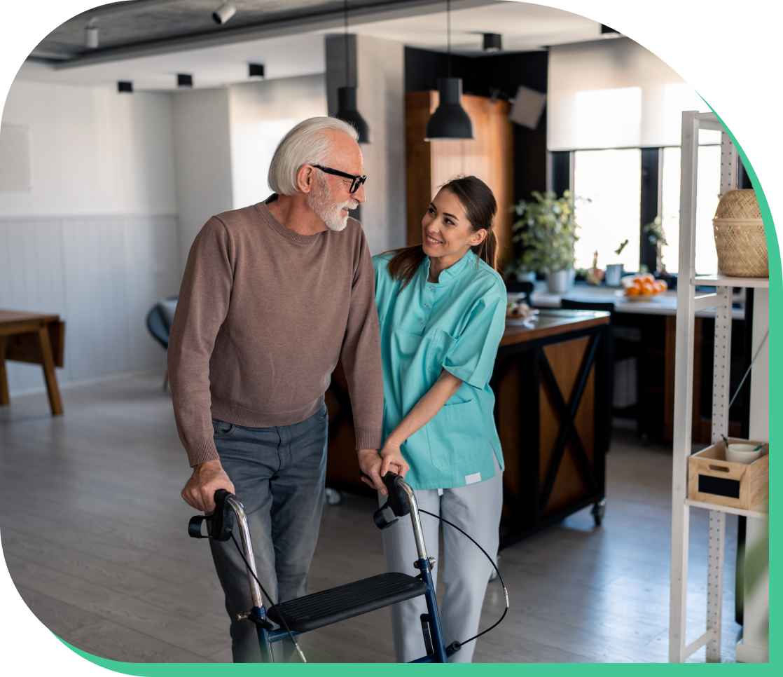 Caregiver assisting an elderly man with a walker in a residential care setting